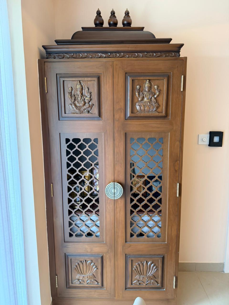 Carved wood pooja cabinet for premium home interiors in Chennai