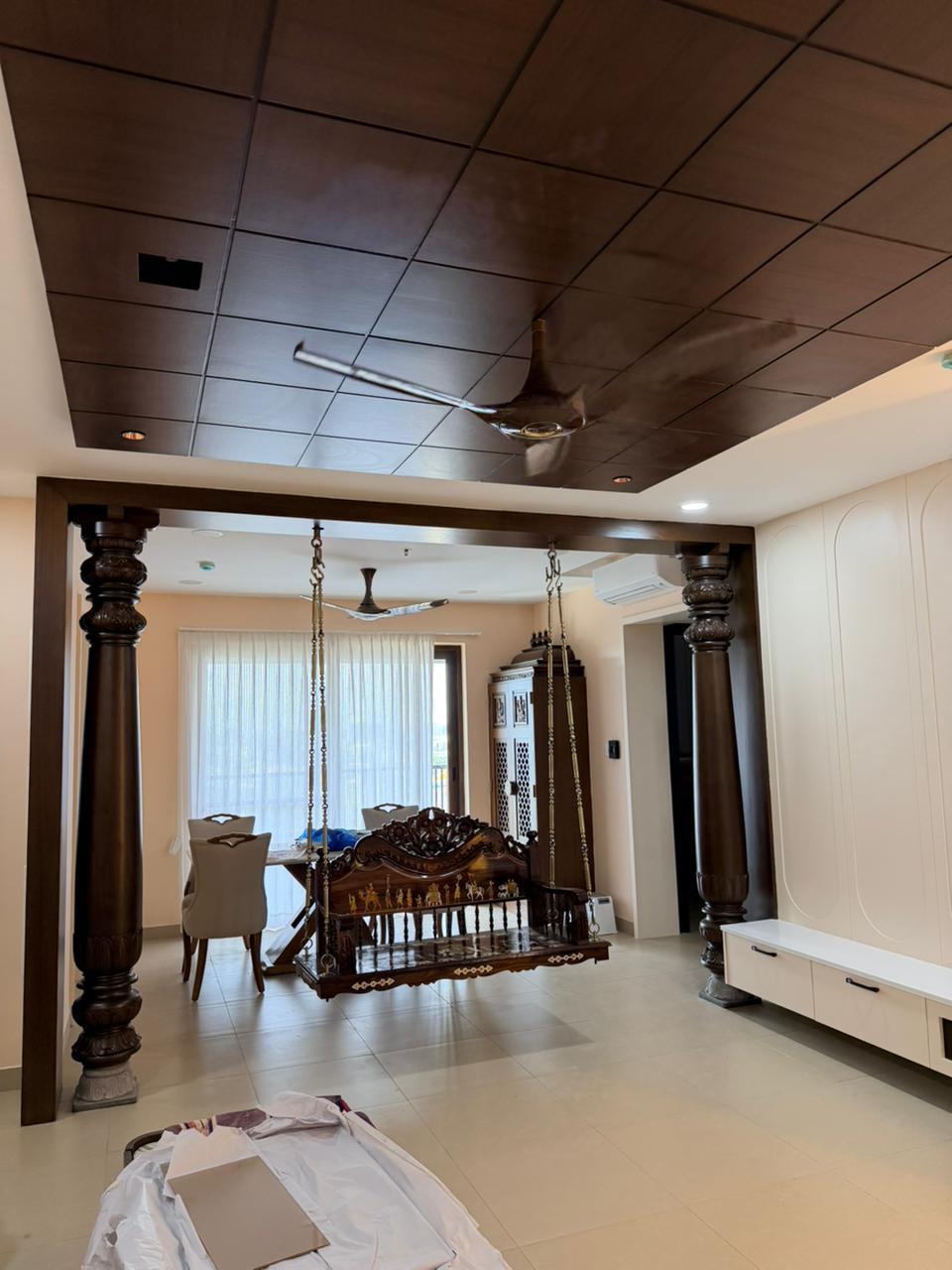 Classic dining hall with swing and wooden pillars in Chennai