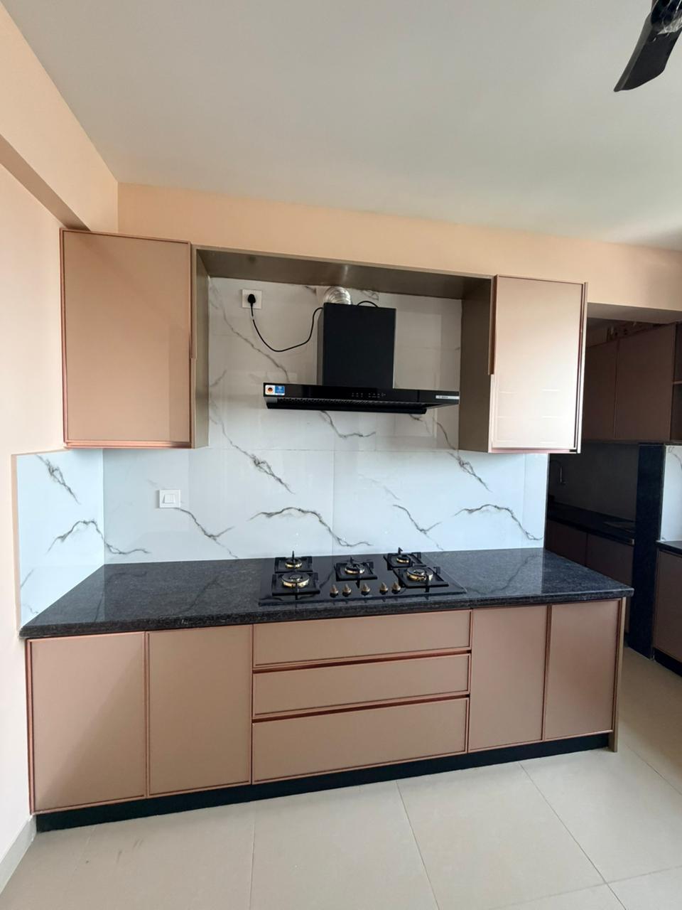 Modern modular kitchen with neutral cabinets in Chennai