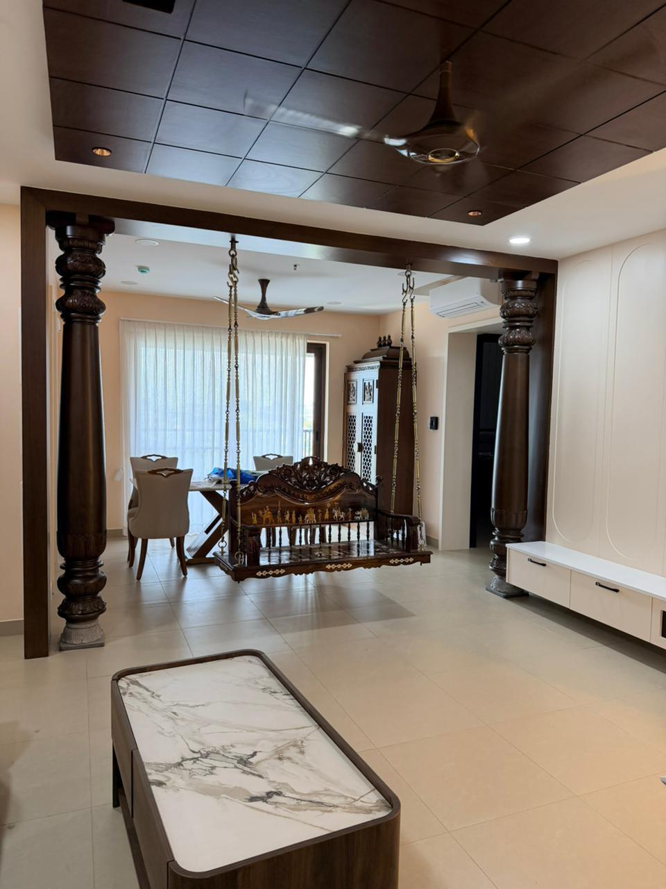 Open dining hall with wood ceiling and columns in Chennai