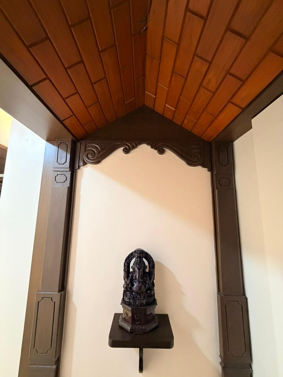Pooja corner with wood ceiling detail for premium home interiors