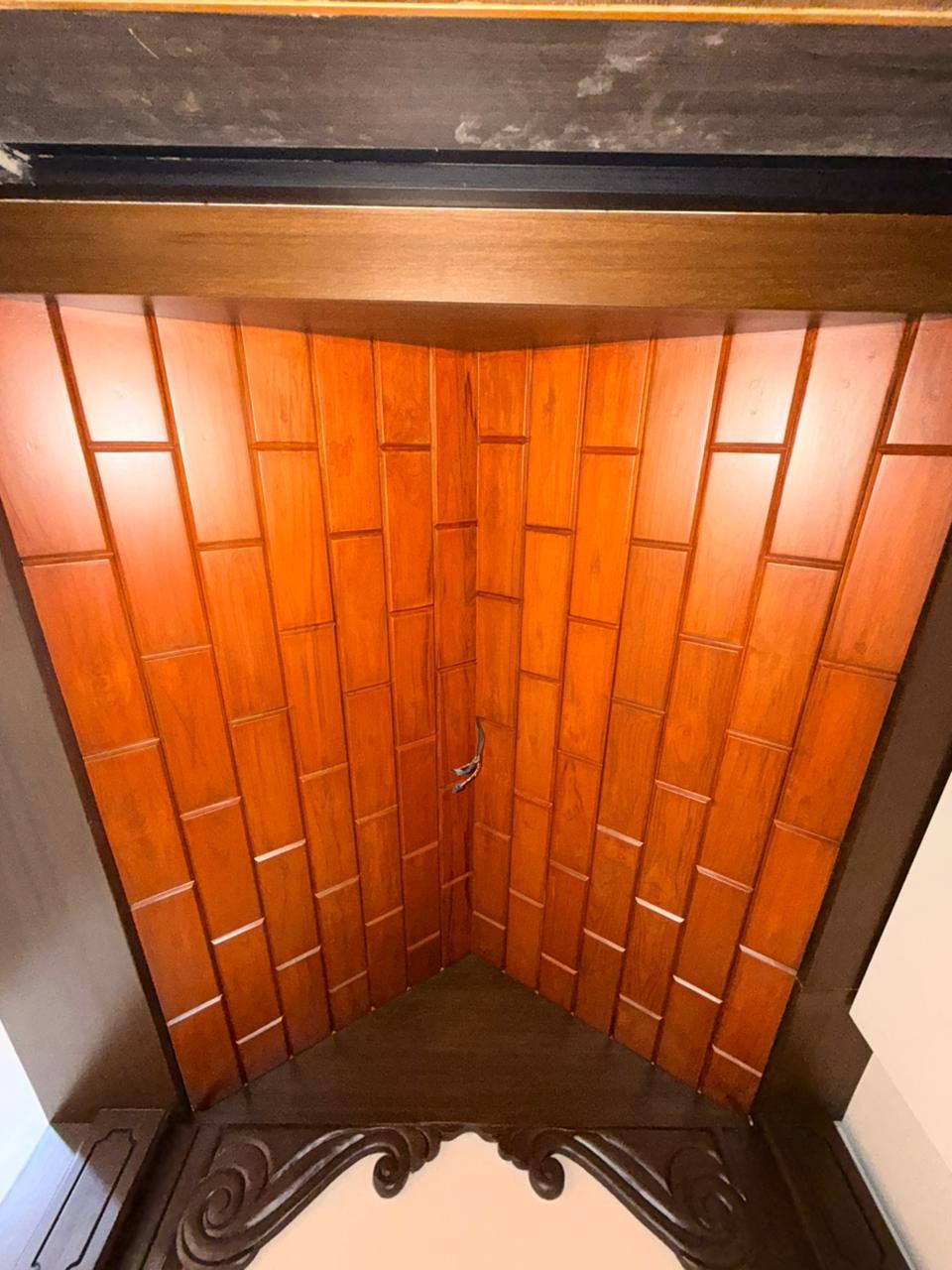 Timber ceiling pooja corner detail for premium Chennai interiors